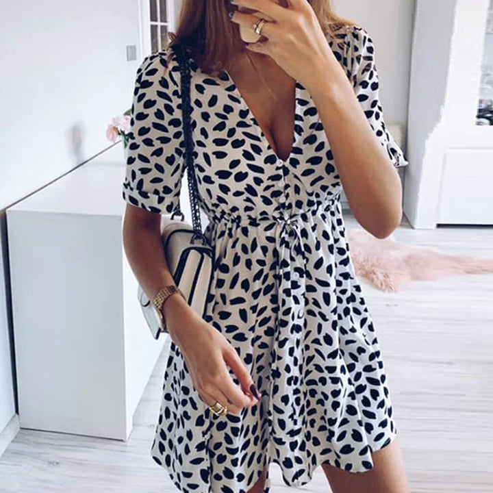 NOVA | Elegant short dress with V-neckline and dot pattern

