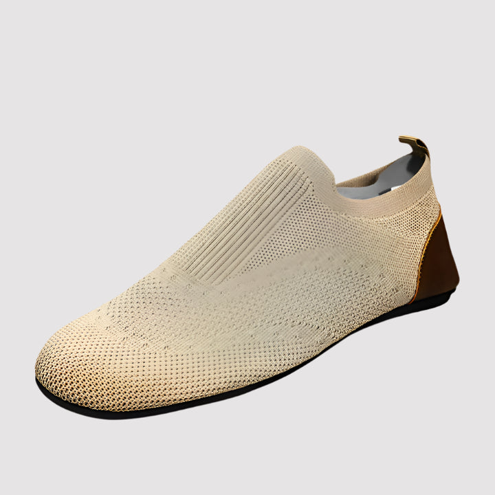 Beige slip-on shoe with brown accent on a white background, featuring the RZL brand logo.